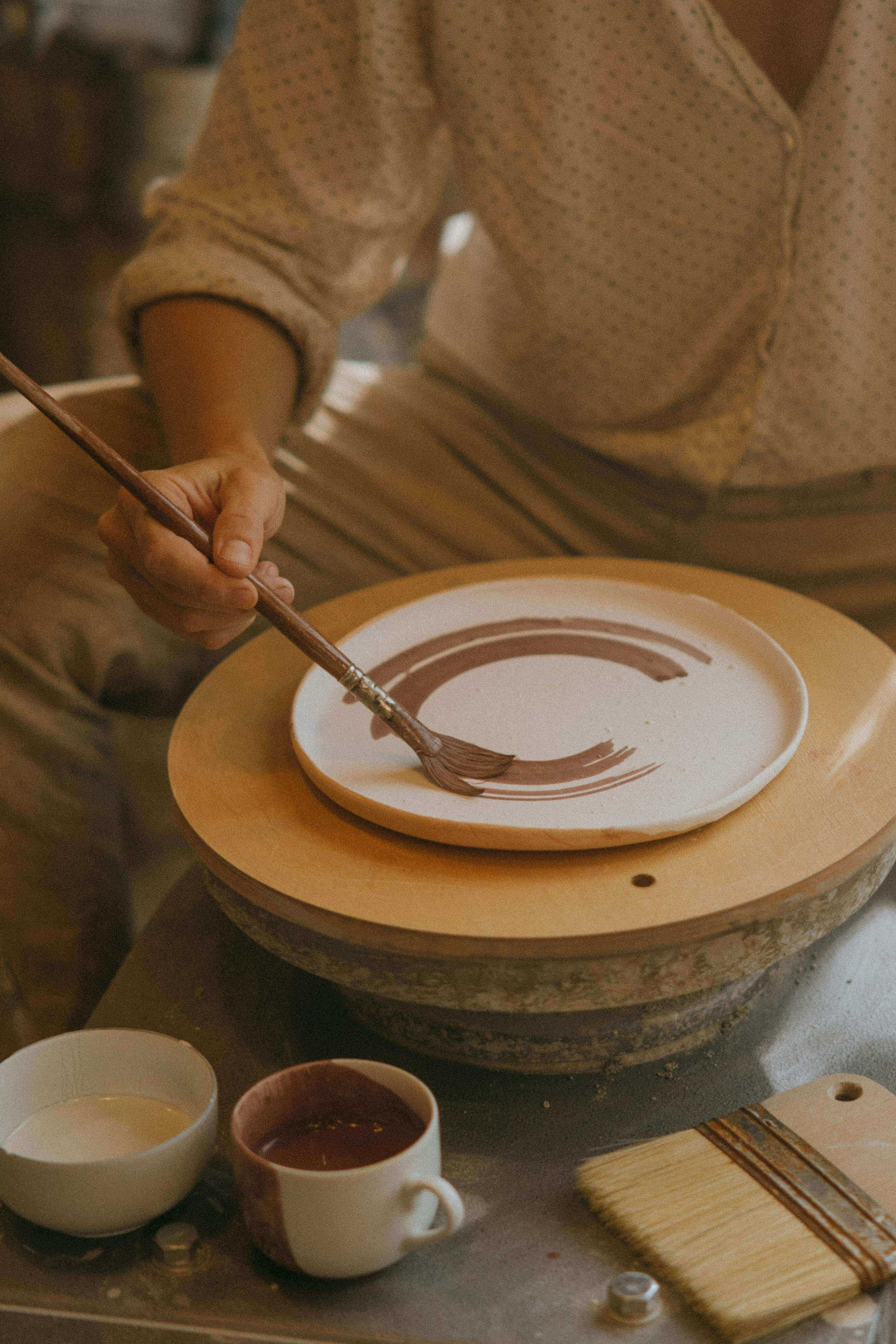 Artisan crafting a small handmade ceramic pot, symbolizing Chascent's dedication to craftsmanship.